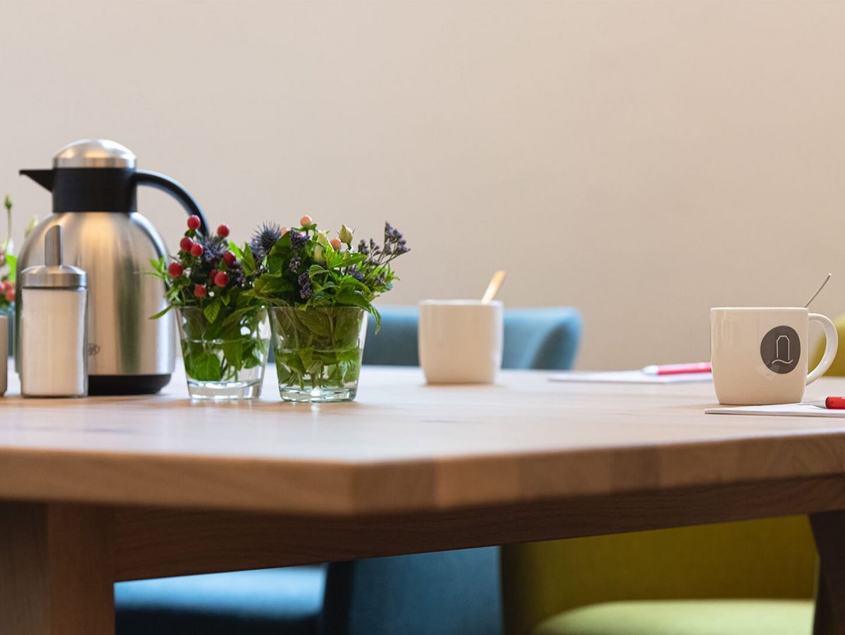 Kaffeekanne und Tassen auf dem Tagungstisch